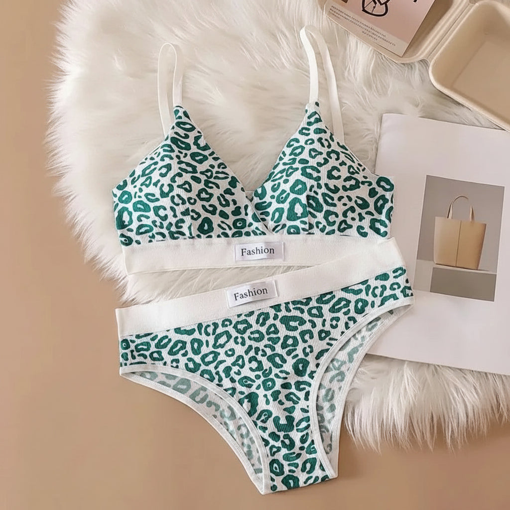 Green leopard print bra and panties set on a beige surface with text in the background