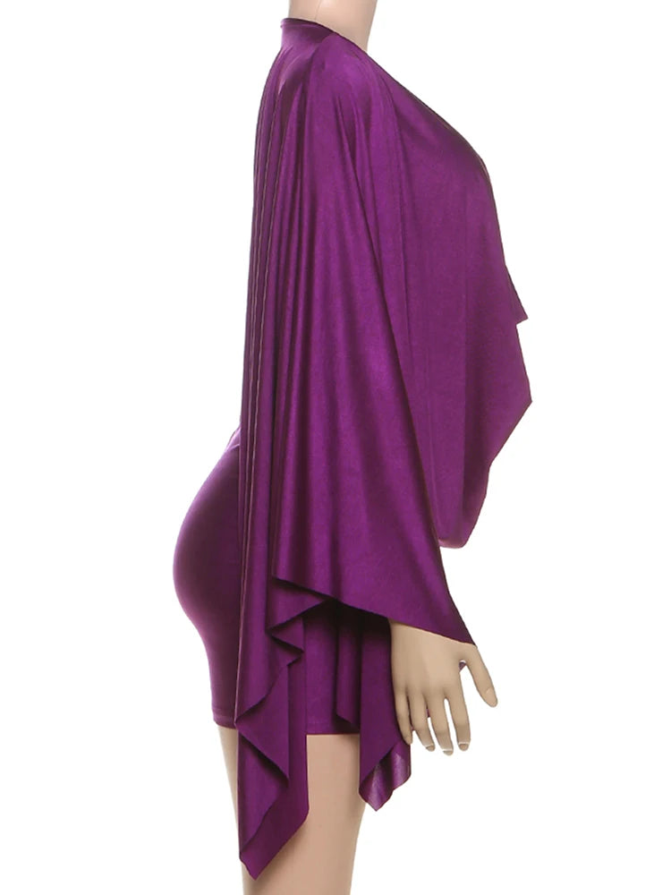 Purple draped dress on a mannequin against a white background