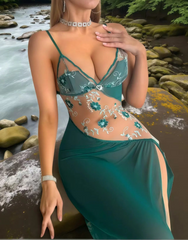 Woman in a green embroidered dress standing by a river with a natural background