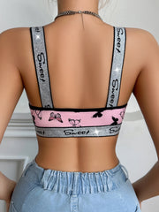 Person wearing a sports bra with 'Sweet' branding and pink butterfly design, paired with light blue jeans.