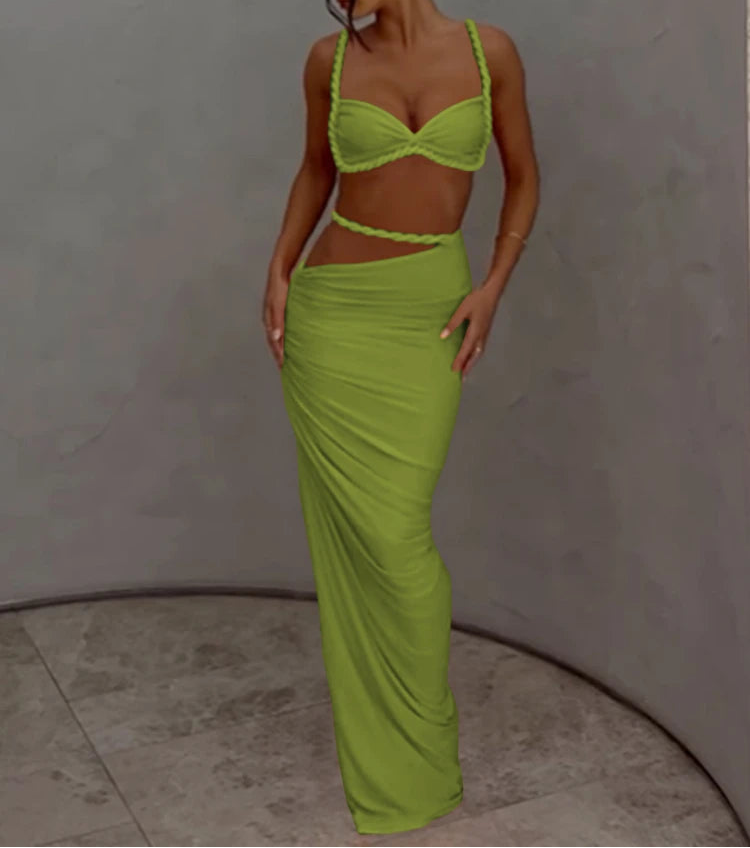 Woman wearing a bright green outfit against a plain background