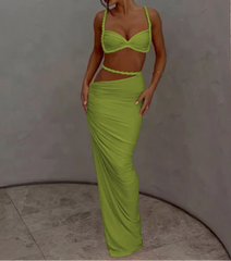 Woman wearing a bright green outfit against a plain background