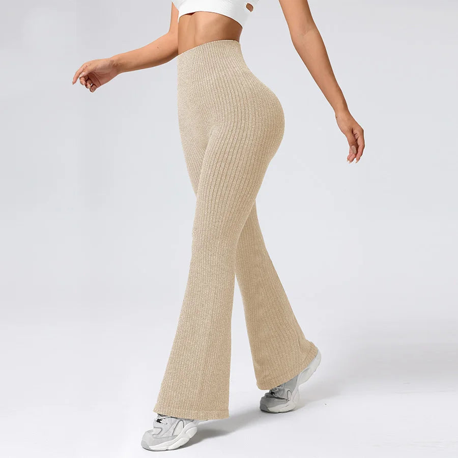 Beige ribbed flared pants worn by a person on a white background