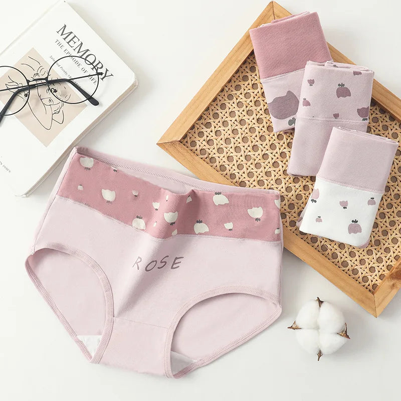 Pink women's underwear with 'ROSE' text and small patterns on a white surface.