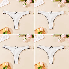 White thong with black lace trim on a beige background with flowers and text.