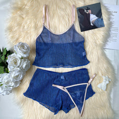 Blue lingerie set with pink straps on a fluffy white surface with flowers and a magazine.