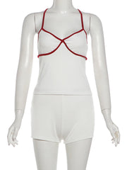 White swimsuit with red straps on a mannequin against a white background