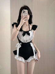 Person wearing a black and white maid outfit taking a mirror selfie.