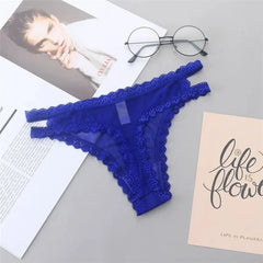 Blue lace lingerie on a gray surface with a magazine and eyeglasses.