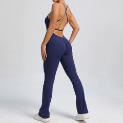 Person wearing a navy blue jumpsuit on a light gray background