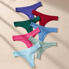 Set of colorful ribbed thongs on a beige background