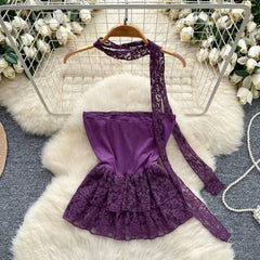 Purple lace dress on a hanger with floral decorations in the background