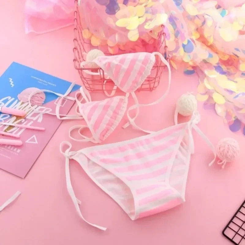 Pink bikini set with accessories on a pink background