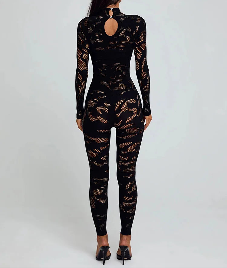 Black fishnet bodysuit worn by a model on a white background