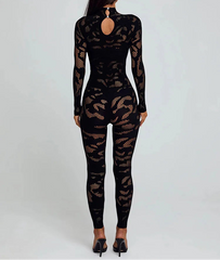Black fishnet bodysuit worn by a model on a white background