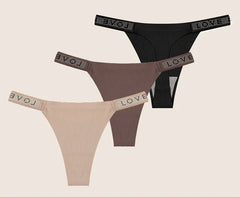 Two pairs of women's panties with rhinestone waistbands on a beige background.