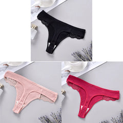 Three pairs of lace-trimmed panties in black, pink, and red on a light gray surface.