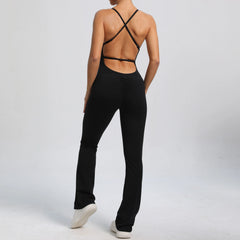 Person wearing a black outfit with open back design on a white background