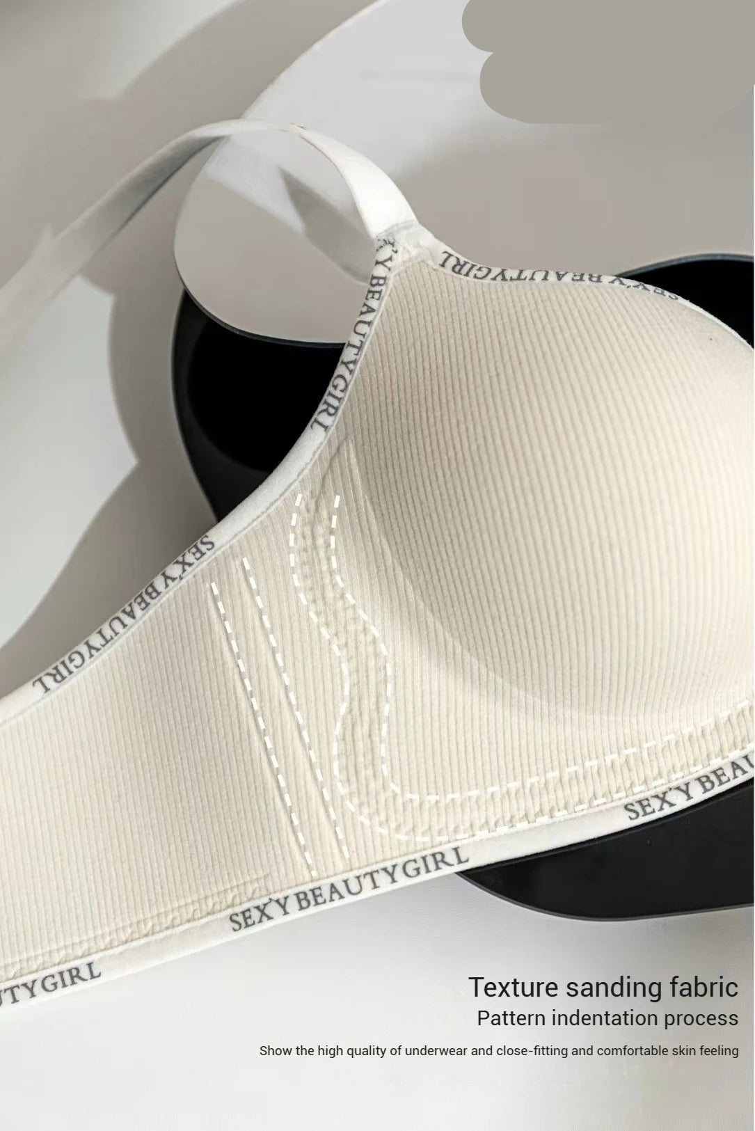 Close-up of a textured sanding fabric with 'SEXYBEAUTYGIRL' branding.