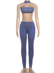 Mannequin wearing a blue and white polka dot bikini set on a white background