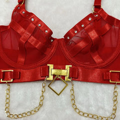 Red bra with gold accents and chains on a light gray background