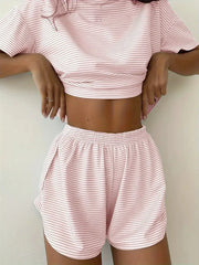 Person wearing a pink and white striped outfit on a plain background
