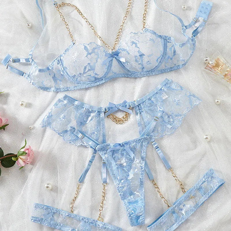 Blue lace lingerie set on a light background with decorative elements.
