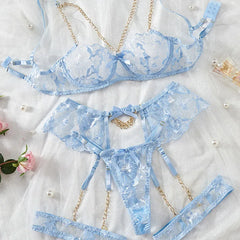 Blue lace lingerie set on a light background with decorative elements.