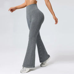 Person wearing gray ribbed knit pants on a white background