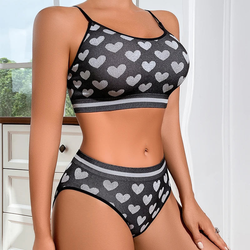 Person wearing a black and white heart-patterned bikini set indoors.