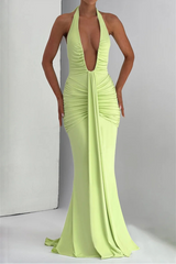 Lime green evening gown with a plunging neckline on a plain background