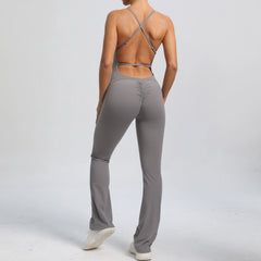 Person wearing a gray jumpsuit with a plain background