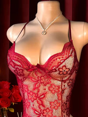 Red lace lingerie on a mannequin with a dark background