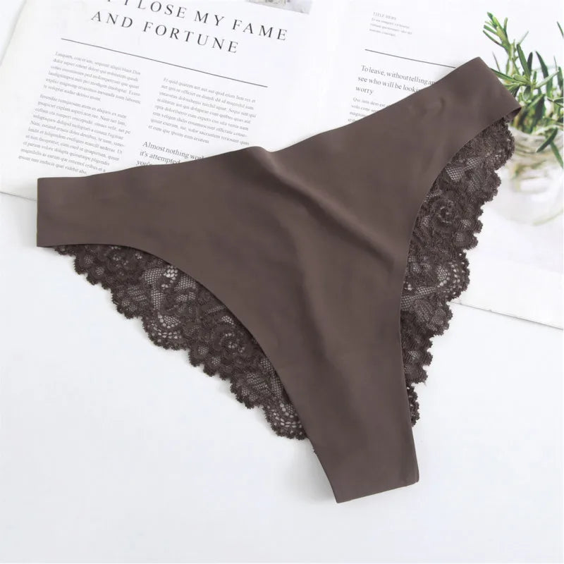 Brown lace thong on a white surface with text and greenery in the background