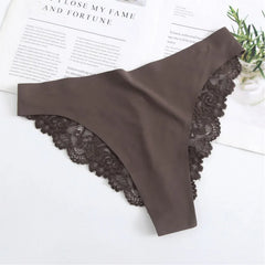 Brown lace thong on a white surface with text and greenery in the background