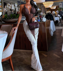 Woman in a stylish outfit standing in an elegant restaurant setting