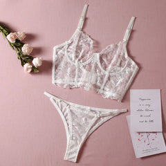 Lace lingerie set with flowers and cards on a pink background