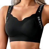 Black sports bra with 'BEAUTY' branding on straps worn by a person.