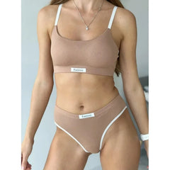 Woman wearing a beige sports bra and underwear set with 'Fashion' label on a light gray background