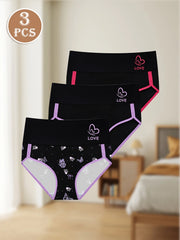 Three pairs of black underwear with pink accents on a neutral background