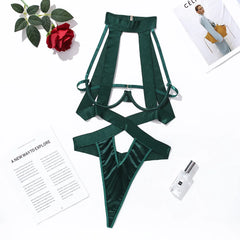 Green satin lingerie set on a white background with a flower and magazine.