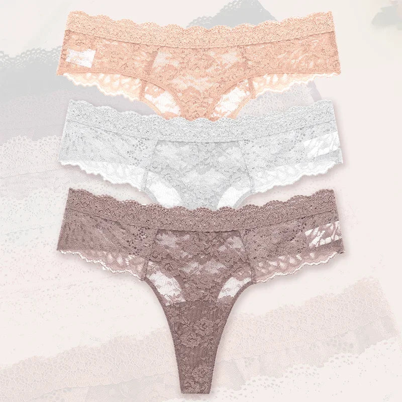 Three pairs of lace underwear in different colors on a light background