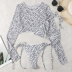 Polka dot swimsuit with matching cover-up on a light surface