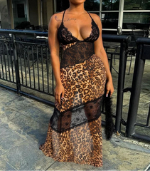 Woman wearing a leopard print dress with black lace overlay outdoors.