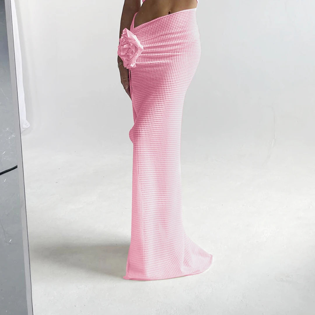 Pink checkered skirt with floral detail on a white background