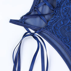 Blue lace lingerie with ribbon details on a white background