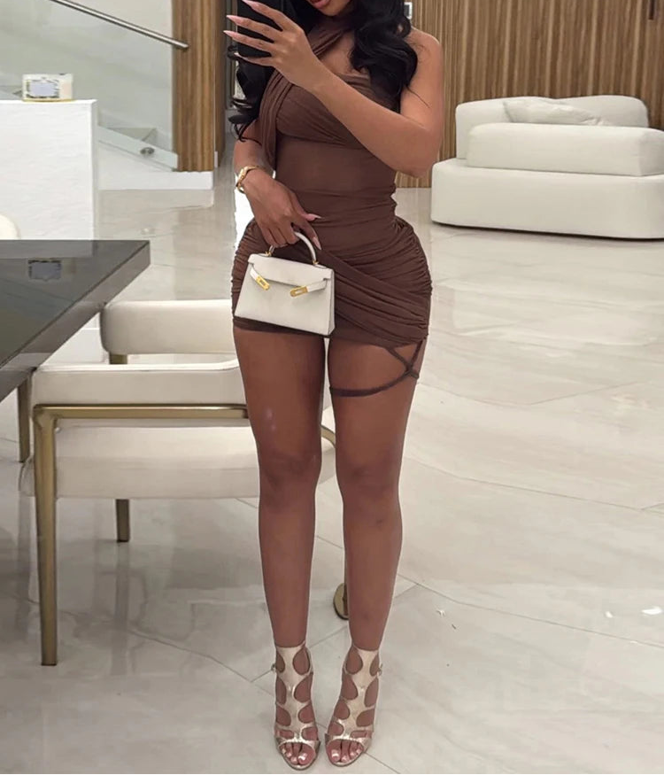 Woman taking a mirror selfie in a stylish outfit in a modern interior setting