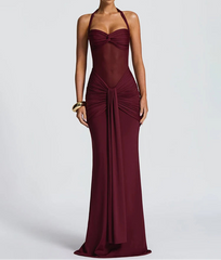 Burgundy evening gown on a model against a light gray background