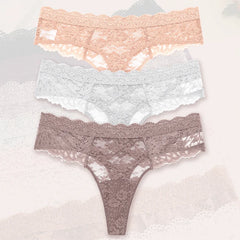 Three pairs of lace underwear in different colors on a light background