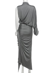 Gray draped dress on a mannequin against a white background